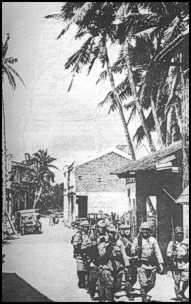 Japanese march through Philippine village